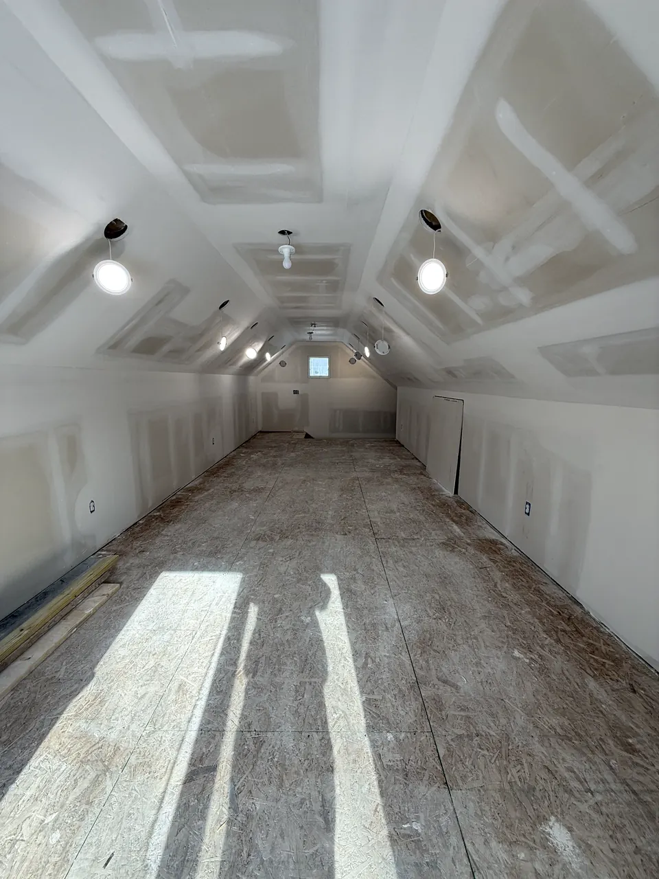 Sloped ceiling with coated drywall seams and light openings